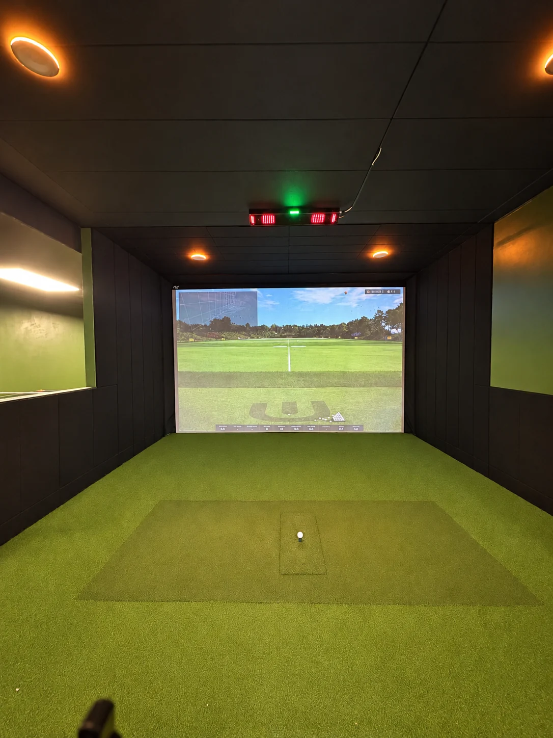 Indoor golf simulator bay at Legacy Golf Lounge